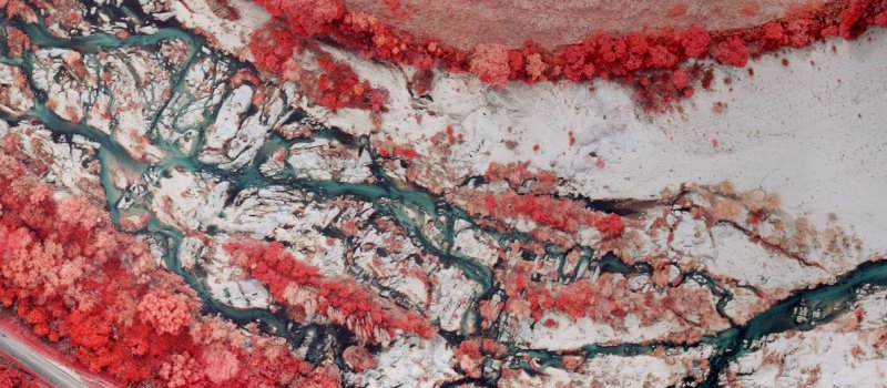 An infrared aerial photo of a river.