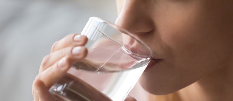 Person drinking a glass of water