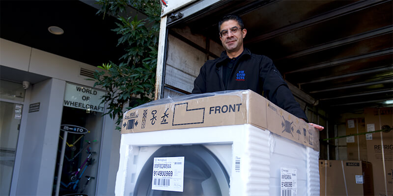 Man in front of a washing machine in a loading dock