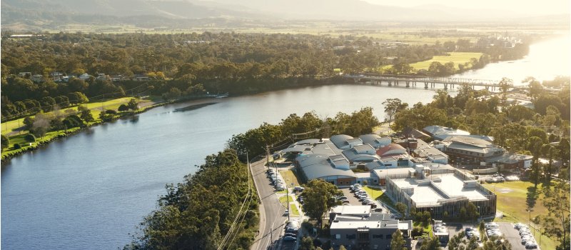 A birds-eye view of a river by a hospital