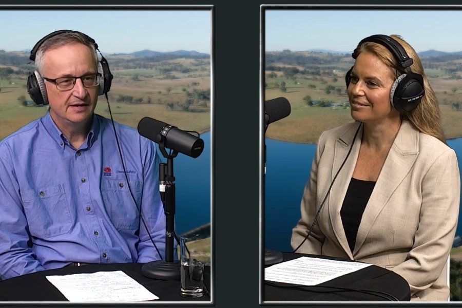 Man and woman wearing headphones speaking into microphones