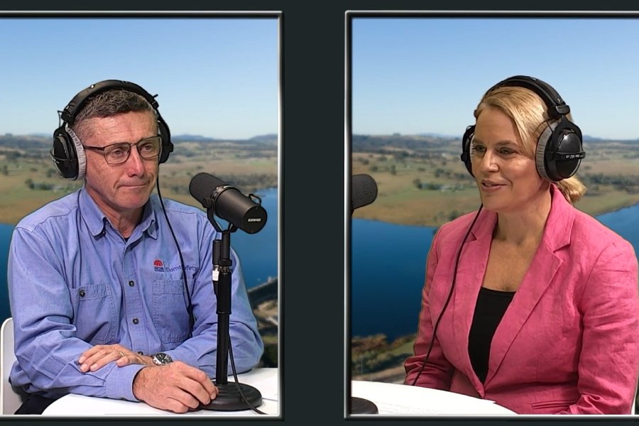 A man and a woman wearing headphones, speaking into microphones
