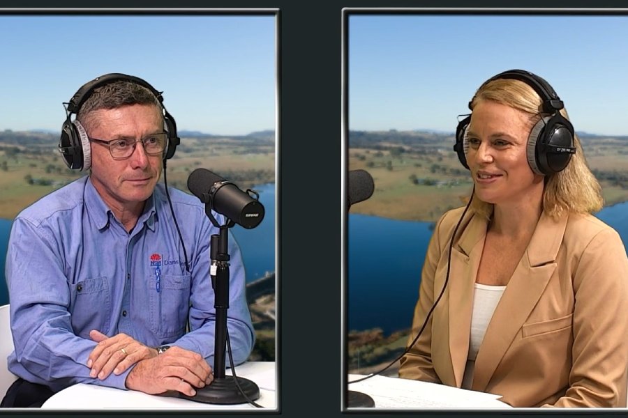 A man and a woman wearing headphones, speaking into microphones