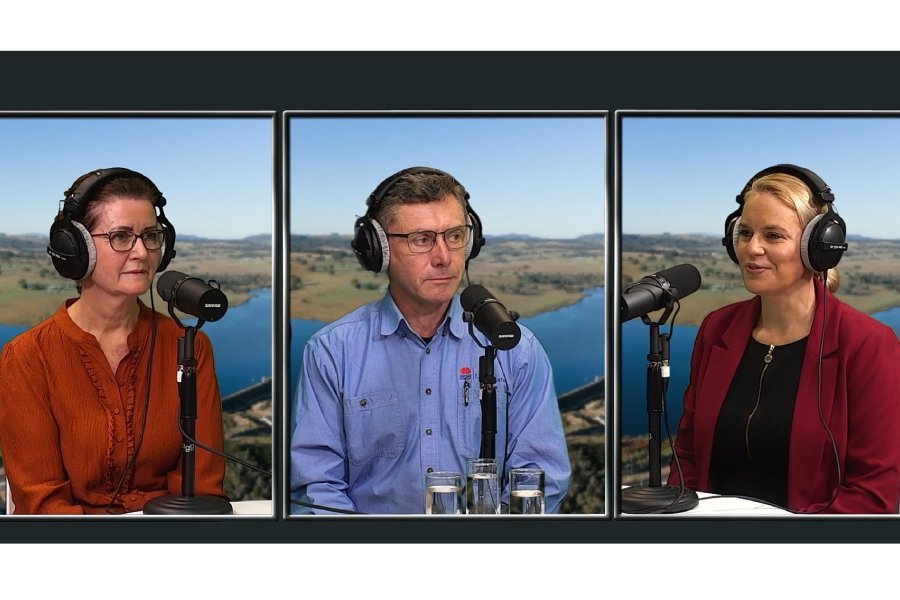 Two women and a man wearing headphones, speaking into microphones