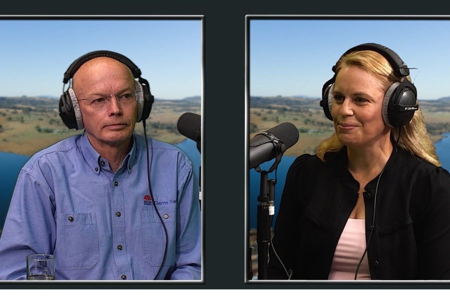 A man and a woman wearing headphones, speaking into microphones