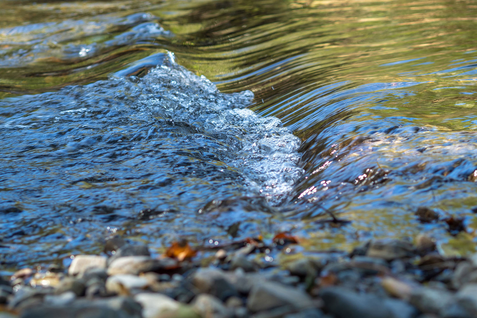 Close up of water rushing over rocks in Never Never River