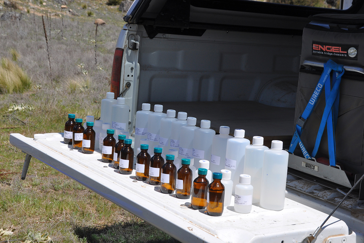 Botttles of resources and nutrients required to support aquatic health lined up on the tailgate of a truck