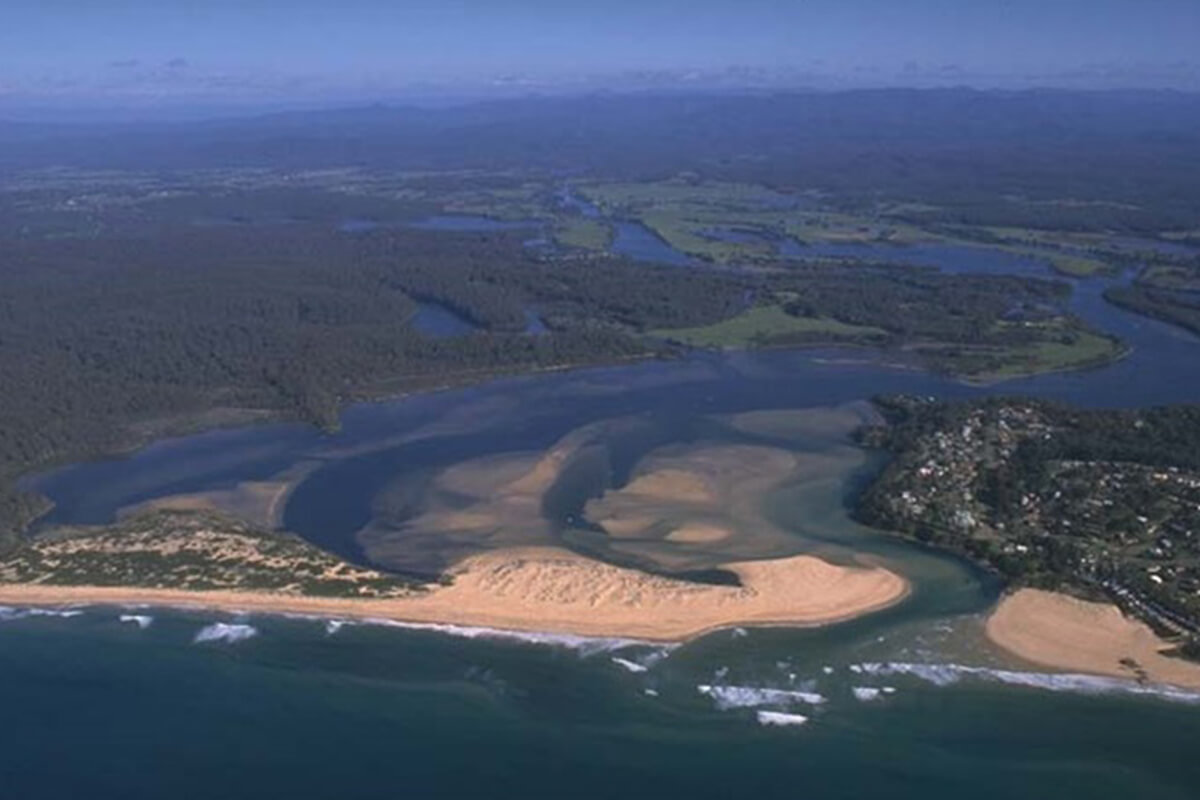 An aerial photo of a river estuary  with winding river and sand banks