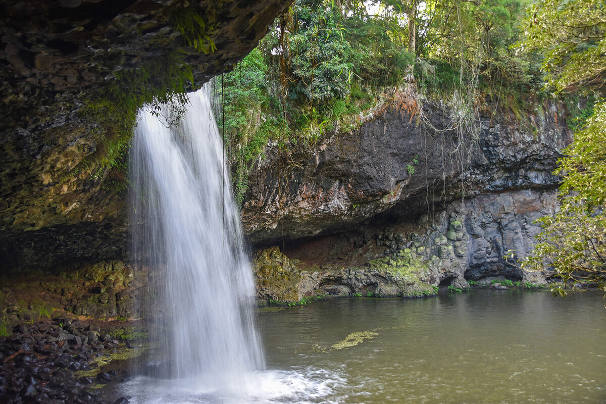 a waterfall runs over a rockey outcrop