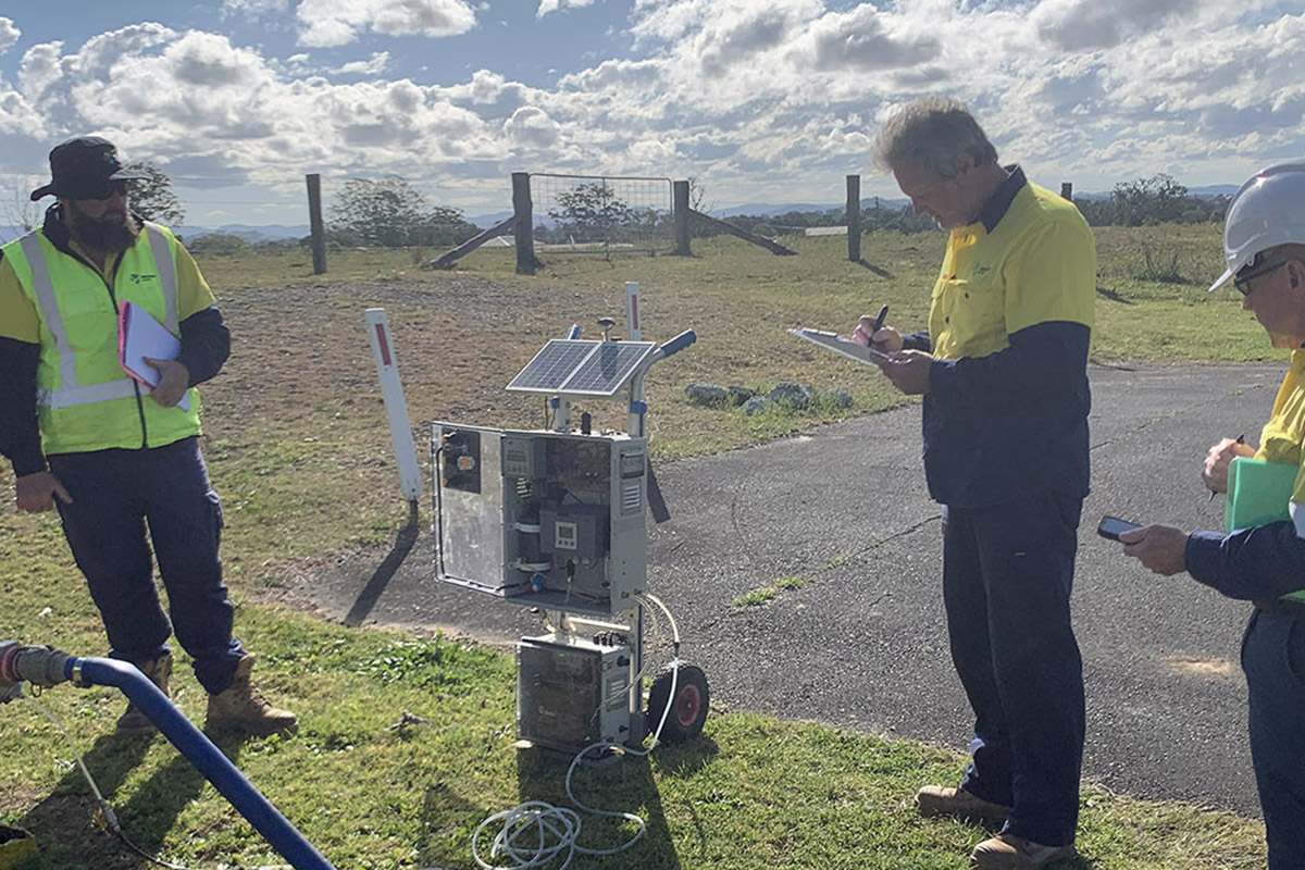 Training course with 3 men in high vi standing outside