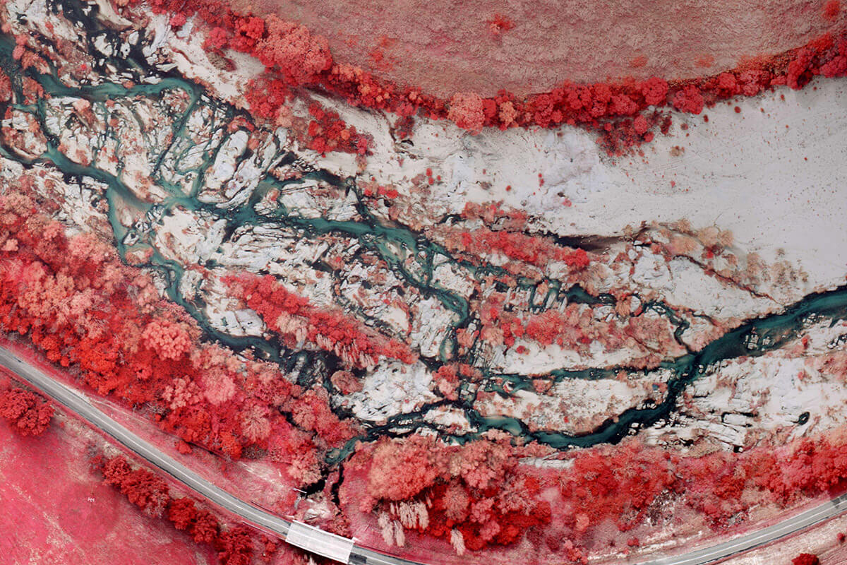 An infrared aerial photo of a river.