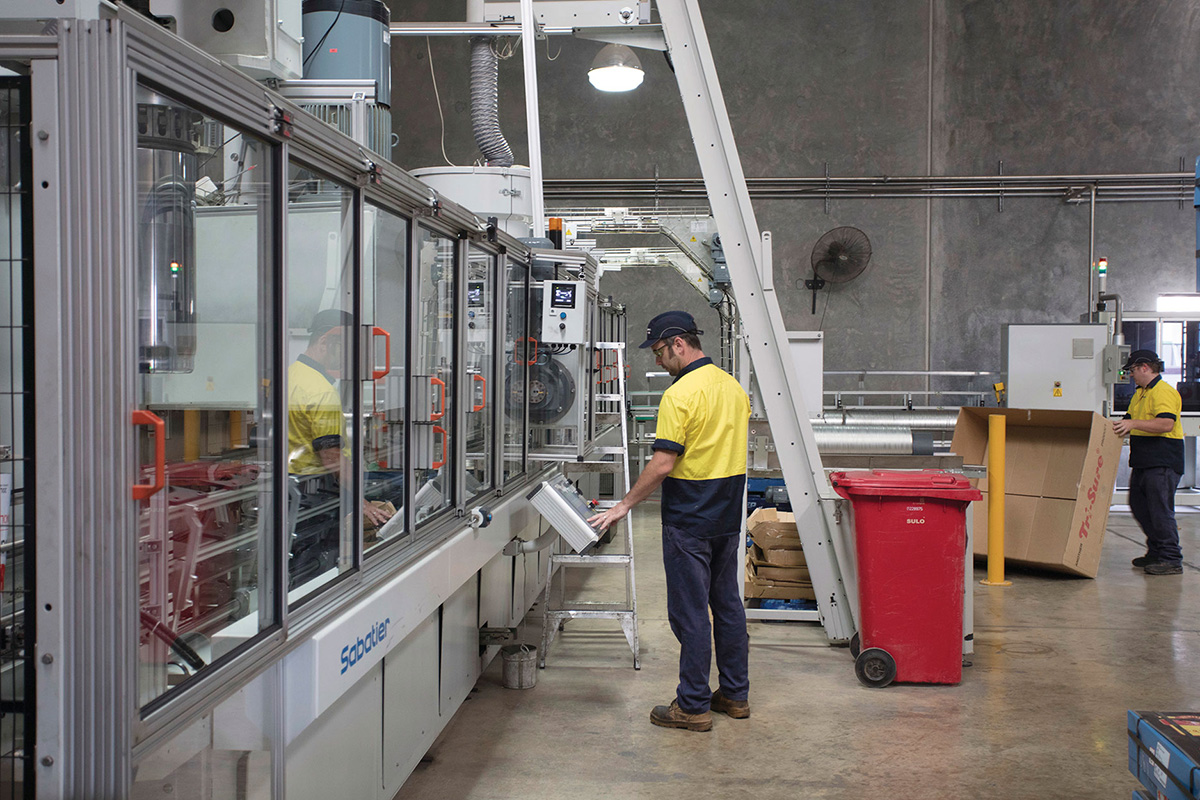 Workers at a Canola production factory at MSM Milling in Manildra
